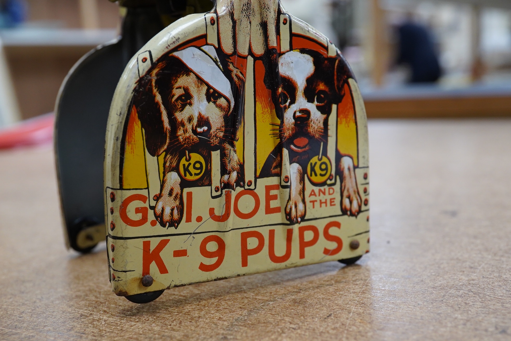 A 1940s clockwork tinplate G.I. Joe and his K-9 Pups by Unique Arts Manufacturing Company Inc, New York. Condition - fair to good.